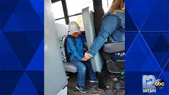School bus driver comforts boy