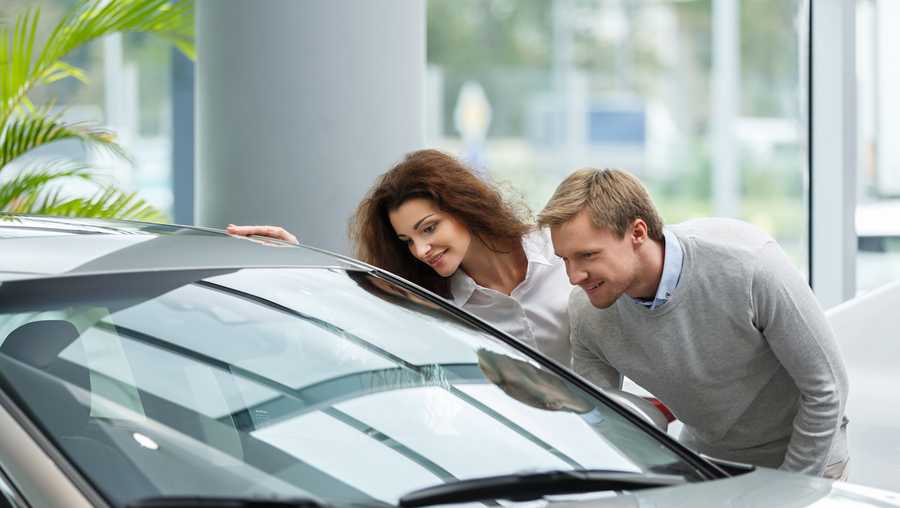 Young couple buying cars