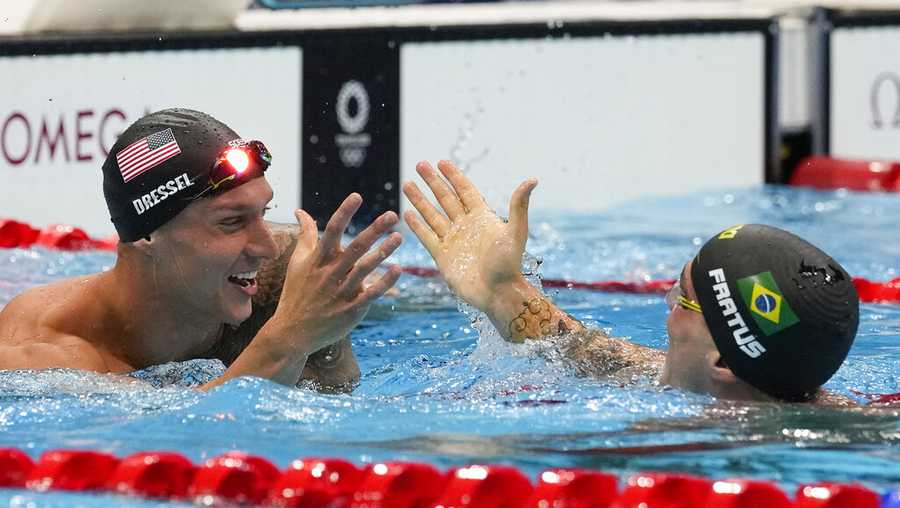 Caeleb Dressel, of United States, celebrates with Bruno Fratus, of Brazil, after winning the gold medal in the men&apos;s 50-meter freestyle final at the 2020 Summer Olympics, Sunday, Aug. 1, 2021, in Tokyo, Japan. (AP Photo/Gregory Bull)