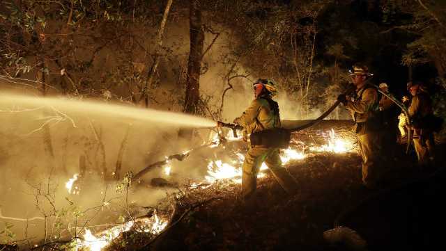Fire crews battle a wildfire Saturday, Oct. 14, 2017, in Santa Rosa, Calif.