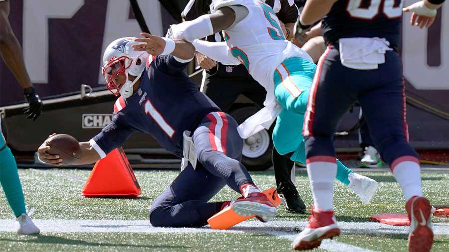 New England Patriots quarterback Cam Newton (1) scores his second rushing touchdown as Miami Dolphins linebacker Jerome Baker (55) chases in the second half of an NFL football game, Sunday, Sept. 13, 2020, in Foxborough, Mass. (AP Photo/Steven Senne)