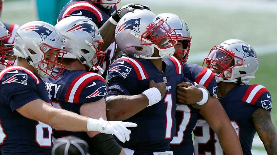 New England Patriots quarterback Cam Newton (1) celebrates his rushing touchdown against the Miami Dolphins with teammates in the first half of an NFL football game, Sunday, Sept. 13, 2020, in Foxborough, Mass. (AP Photo/Steven Senne)