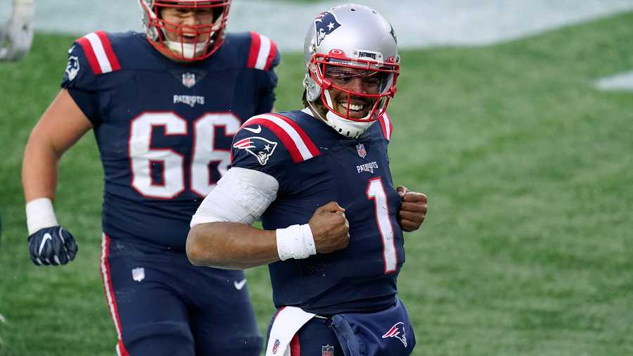New England Patriots quarterback Cam Newton, right, celebrates his touchdown catch of a pass thrown by wide receiver Jakobi Meyers as offensive lineman James Ferentz (66) joins him during the second half of an NFL football game against the New York Jets, Sunday, Jan. 3, 2021, in Foxborough, Mass. (AP Photo)