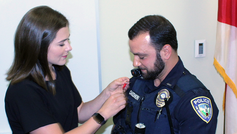 Shannon Canzoneri pins the Medal of Honor on her husband, UAPD Officer Albert Canzoneri.