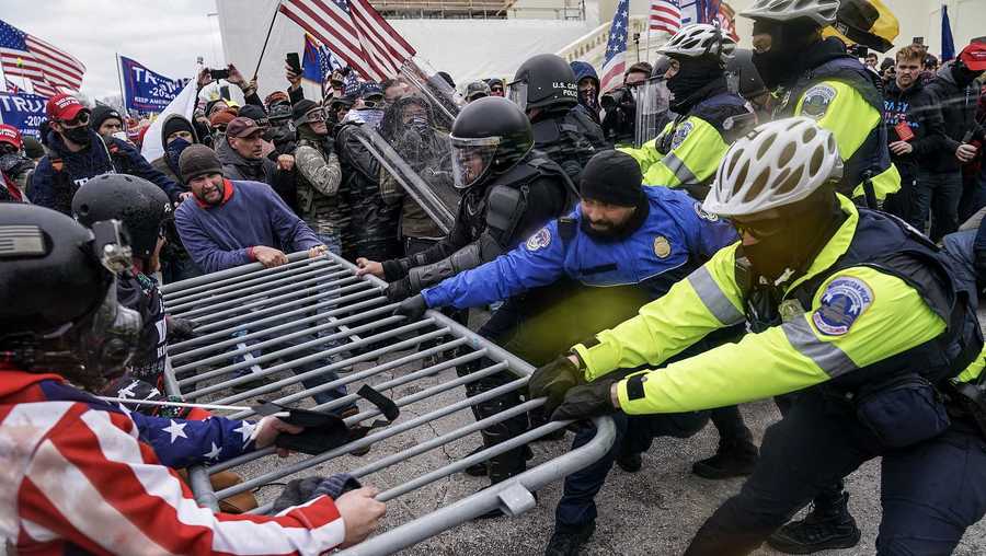 In this Jan. 6, 2021, file photo violent insurrectionists loyal to President Donald Trump supporters try to break through a police barrier at the Capitol in Washington.