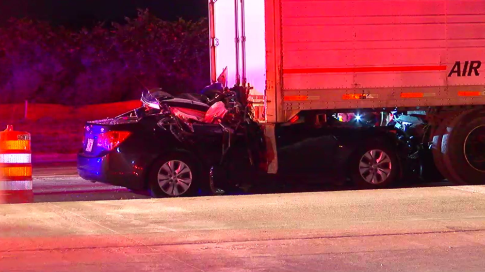 Half of car crushed under semitruck in deadly wreck