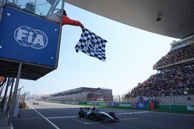 Mercedes driver George Russell of Britain crosses the finish line and wins the Sprint Race of the Chinese Formula One Grand Prix at the Shanghai International Circuit, in Shanghai, China, Saturday, March 14, 2026.