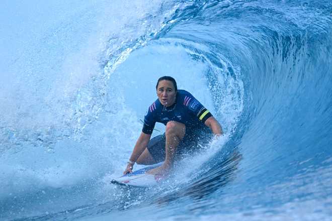 US&#x20;surfer&#x20;Carissa&#x20;Moore&#x20;competes&#x20;in&#x20;the&#x20;women&amp;apos&#x3B;s&#x20;quarterfinal&#x20;round&#x20;of&#x20;the&#x20;Shiseido&#x20;Tahiti&#x20;Pro&#x20;surfing&#x20;competition&#x20;against&#x20;Costa&#x20;Rican&#x20;surfer&#x20;Brisa&#x20;Hennessy&#x20;&#x28;not&#x20;pictured&#x29;,&#x20;in&#x20;Teahupo&amp;apos&#x3B;o,&#x20;on&#x20;the&#x20;French&#x20;Polynesian&#x20;Island&#x20;of&#x20;Tahiti,&#x20;on&#x20;May&#x20;29,&#x20;2024.&#x20;Teahupo&amp;apos&#x3B;o&#x20;will&#x20;host&#x20;the&#x20;surfing&#x20;event&#x20;of&#x20;the&#x20;Paris&#x20;2024&#x20;Olympic&#x20;Games.&#x20;&#x28;Photo&#x20;by&#x20;JEROME&#x20;BROUILLET&#x20;&#x2F;&#x20;AFP&#x29;&#x20;&#x28;Photo&#x20;by&#x20;JEROME&#x20;BROUILLET&#x2F;AFP&#x20;via&#x20;Getty&#x20;Images&#x29;