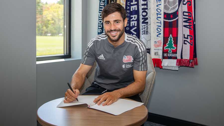 New England Revolution midfielder and captain Carles Gil signs his contract extension on May 24, 2021.
