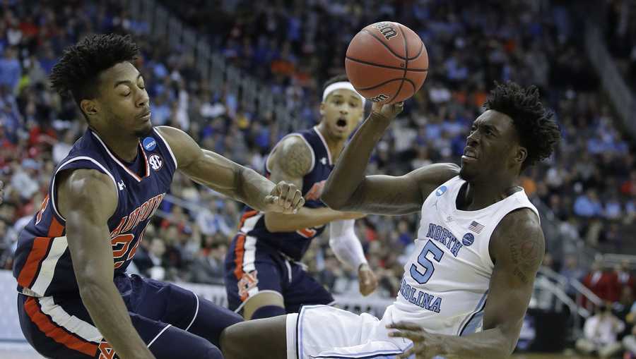 North Carolina's Nassir Little (5) tries to get off a shot as Auburn's Anfernee McLemore and Bryce Brown (2) defend during the first half of a men's NCAA tournament college basketball Midwest Regional semifinal game Friday, March 29, 2019, in Kansas City, Mo. 