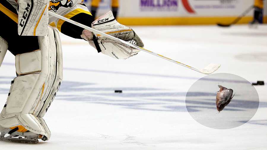 Penguins goalie Marc-Andre Fleury flips a catfish off the ice in Nashville.