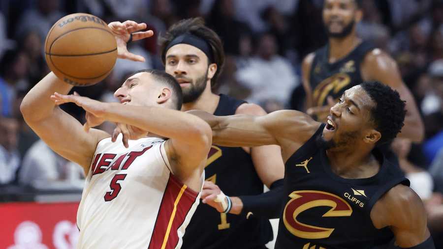 Cleveland Cavaliers guard Donovan Mitchell (45) fouls Miami Heat forward Nikola Jovic (5) during the first half in Game 4 of an NBA basketball first-round playoff series, Monday, April 28, 2025.
