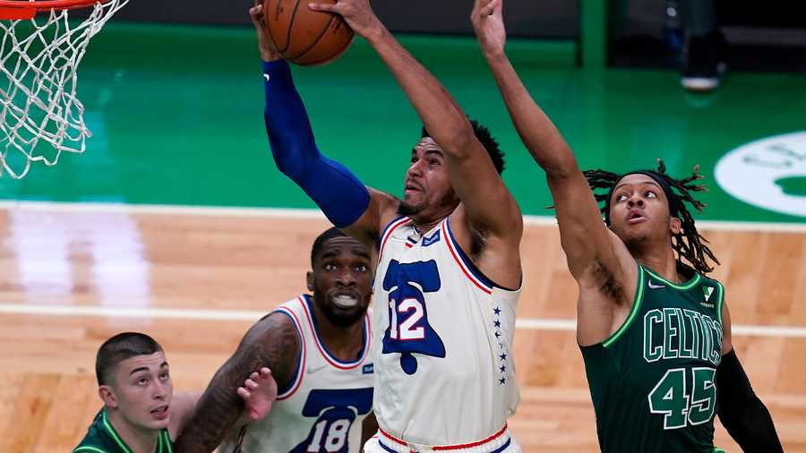 Philadelphia 76ers forward Tobias Harris (12) grabs a rebound against Boston Celtics guard Romeo Langford (45) during the first half of an NBA basketball game, Tuesday, April 6, 2021, in Boston. (AP Photo)