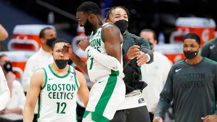 Boston Celtics guard Jaylen Brown, front left, celebrates with guard Carsen Edwards late in the second half of an NBA basketball game against the Denver Nuggets, Sunday, April 11, 2021, in Denver. (AP Photo)
