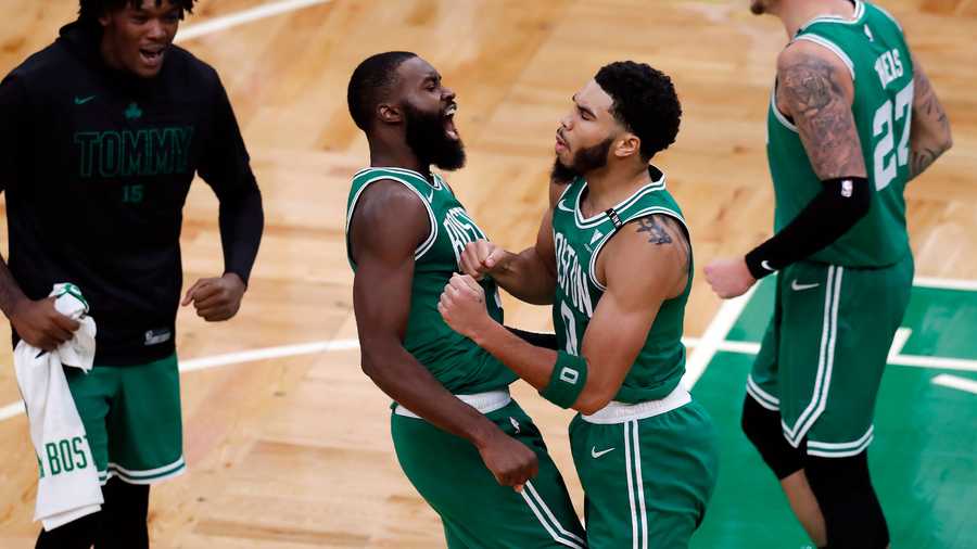 Boston Celtics' Jayson Tatum (0) celebrates with Jaylen Brown (7) after making the go-ahead basket with less than a second on the clock during the second half of an NBA basketball game against the Milwaukee Bucks, Wednesday, Dec. 23, 2020, in Boston. (AP Photo)