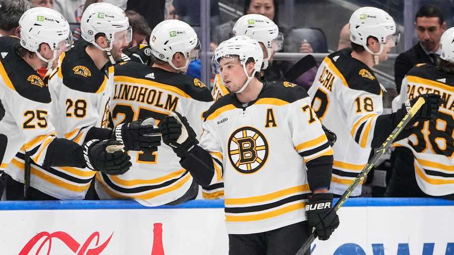 Boston Bruins' Charlie McAvoy, right, celebrates his goal against