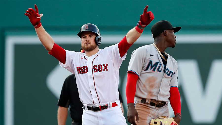 Boston Red Sox's Christian Arroyo, left, reacts beside Miami Marlins' Jazz Chisholm Jr. after hitting a two-run single during the fourth inning of a baseball game, Monday, June 7, 2021, in Boston. (AP Photo)