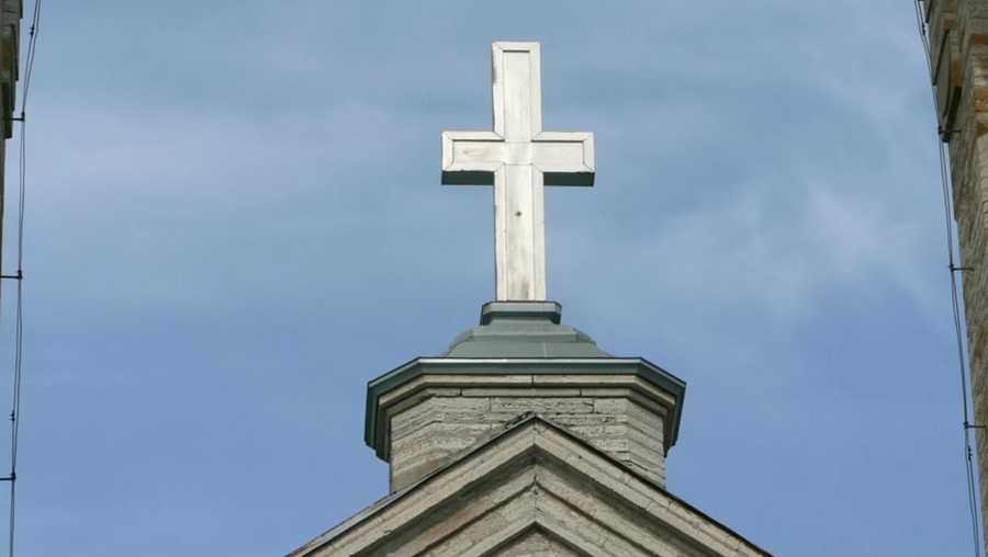 Cross symbol over church