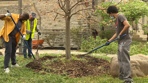 Volunteers clean up debris and mulch for Avondale Cleanup Day