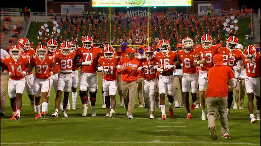 Dabo Swinney locks arms with his players for the Tigers pregame 'walk of champions' prior to their contest against Virginia, Saturday, Oct. 3