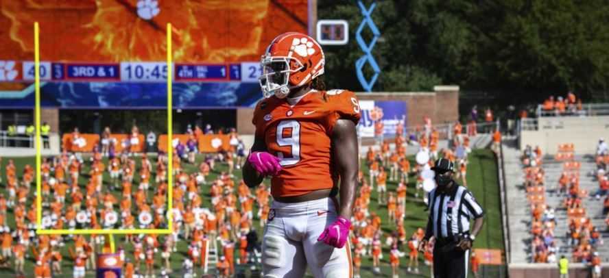 In this Oct. 24, 2020, file photo, Clemson running back Travis Etienne (9) spins the ball out of his hands after scoring a touchdown during an NCAA college football game against Syracuse in Clemson, S.C.