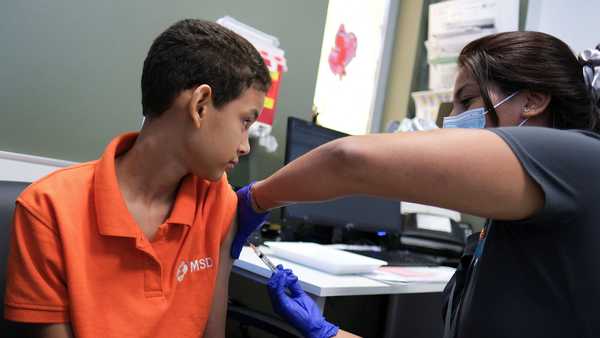 A registered nurse injects a dose of the dengue vaccine to Alberto Luis Nunez, 12, after a spike in dengue cases in San Juan, Puerto Rico, this month.