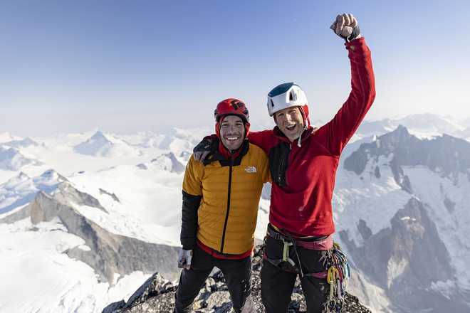 Alex Honnold and Tommy Caldwell celebrate on top of the Devil's Thumb.