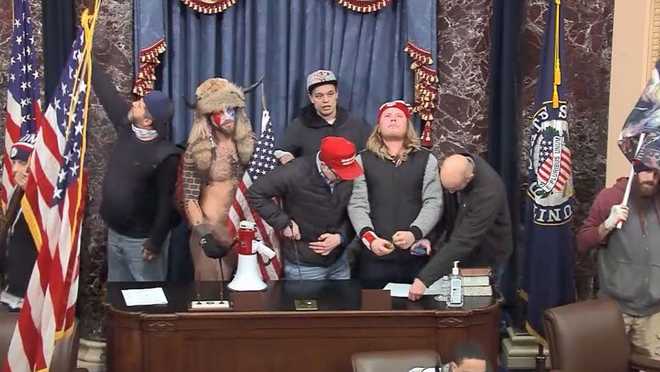 In&#x20;this&#x20;photograph&#x20;included&#x20;in&#x20;a&#x20;statement&#x20;of&#x20;facts&#x20;document&#x20;by&#x20;the&#x20;U.S.&#x20;District&#x20;Court&#x20;for&#x20;the&#x20;District&#x20;of&#x20;Columbia,&#x20;Christopher&#x20;Moynihan,&#x20;seen&#x20;at&#x20;center&#x20;in&#x20;the&#x20;gray&#x20;hat,&#x20;stands&#x20;in&#x20;the&#x20;Senate&#x20;Chamber&#x20;during&#x20;the&#x20;January&#x20;6,&#x20;2021,&#x20;attack&#x20;on&#x20;the&#x20;U.S.&#x20;Capitol.&#x20;Moynihan&#x20;has&#x20;been&#x20;arrested&#x20;after&#x20;allegedly&#x20;making&#x20;threats&#x20;against&#x20;Democratic&#x20;House&#x20;Minority&#x20;Leader&#x20;Hakeem&#x20;Jeffries.