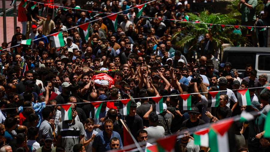 People carry the body of Saif Musallet, who was beaten to death by Israeli settlers, during his funeral near Ramallah, in the Israel-occupied West Bank on July 13.