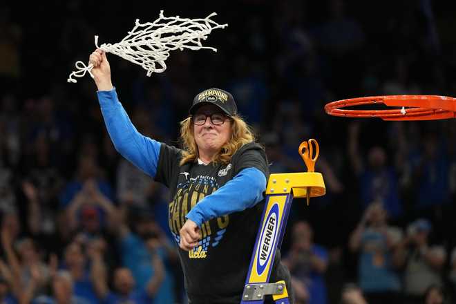 UCLA head coach Cori Close celebrates with the net after UCLA defeated South Carolina in the women's National Championship Final Four NCAA college basketball tournament game, Sunday, April 5, 2026, in Phoenix.