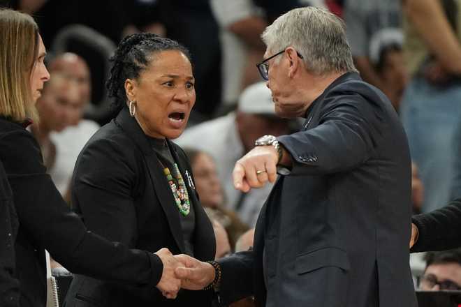 South Carolina head coach Dawn Staley, left, and UConn head coach Geno Auriemma argue after a woman's NCAA college basketball tournament semifinal game at the Final Four, Friday, April 3, 2026, in Phoenix.