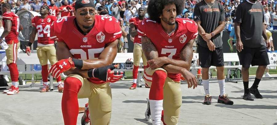 San Francisco 49ers safety Eric Reid (35) and quarterback Colin Kaepernick (7) kneel during the national anthem before an NFL football game against the Los Angeles Rams in Santa Clara, Calif., Monday, Sept. 12, 2016.