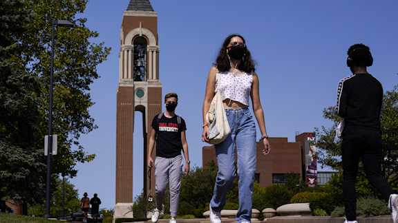 Masked students walk through the campus of Ball State University in Muncie, Ind., Thursday, Sept. 10, 2020.