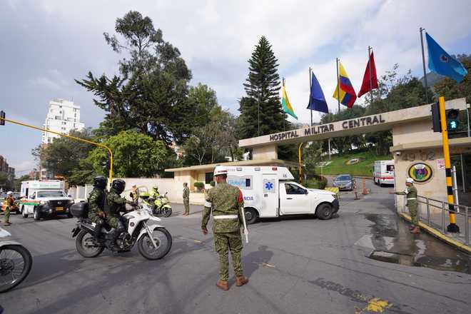 Ambulances carrying people who were injured on a military cargo plane that crashed shortly after takeoff in Puerto Leguizamo arrive at the Military Hospital in Bogota, Colombia, Monday, March 23, 2026.