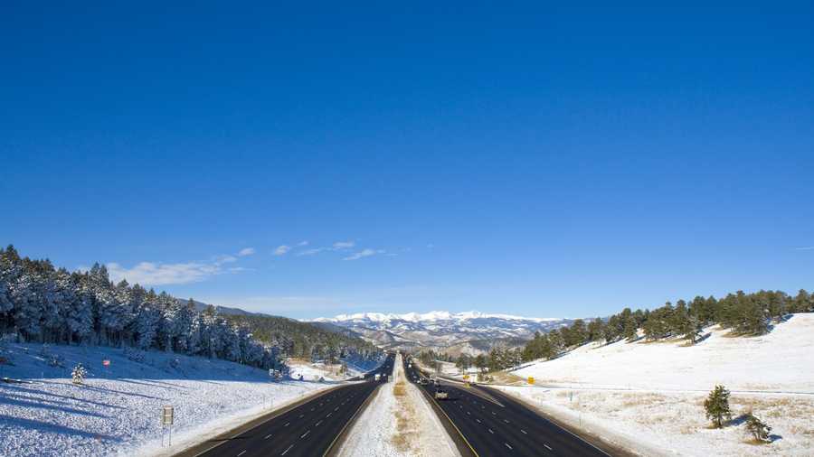 Snow covers the landscape surrounding I-75 facing west towards the Rocky Mountains.