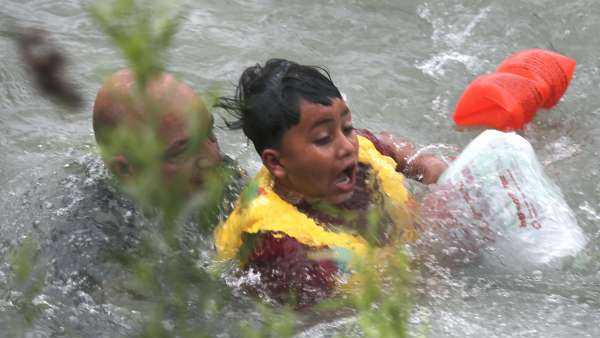 A Border Patrol agent rescues a 7-year-old boy from the raging waters of the Rio Grande.