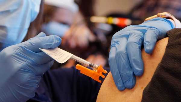 Ohio State University clinic manager Paige Blankenship, left, administers one of the first Johnson & Johnson COVID-19 vaccines to Osvaldo Campanella Tuesday, March 2, 2021, in Columbus, Ohio.