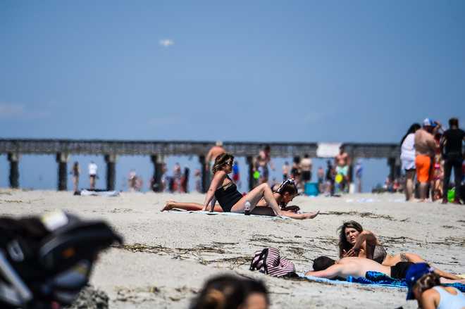 People relax on the Beach amid the Coronavirus pandemic in Tybee Island, Georgia on April 25, 2020.