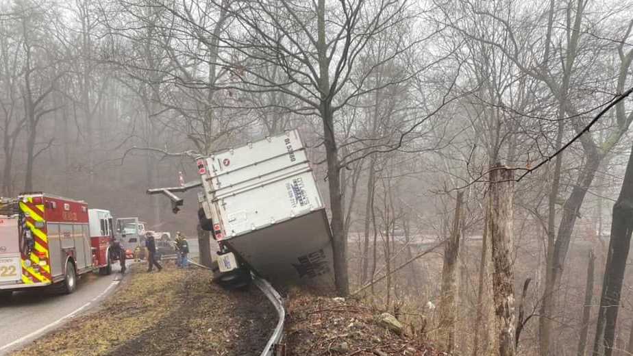Semi left dangling over guardrail after crash on Corydon Pike