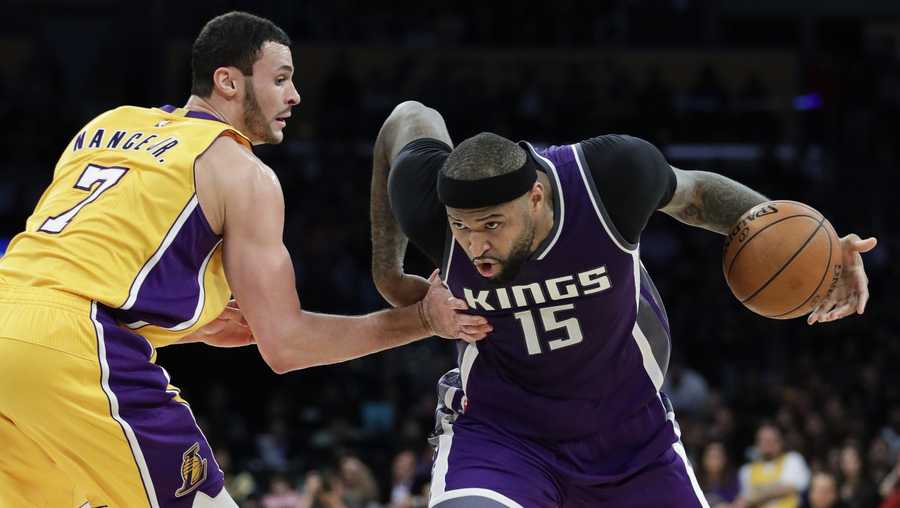Sacramento Kings' DeMarcus Cousins, right, drives past Los Angeles Lakers' Larry Nance Jr. during the second half of an NBA basketball game, Tuesday, Feb. 14, 2017, in Los Angeles.