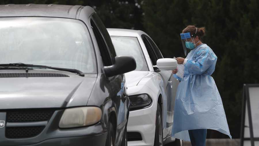 Cars line up at a community coronavirus testing site operated by Cone Health and the county Health Department in Burlington, N.C., Thursday, July 9, 2020. The public testing was drive-up or walk-up with no appointment needed.
