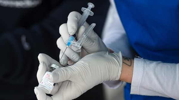 Reading, PA - April 19: A nurse fills a syringe with COVID-19 vaccine.