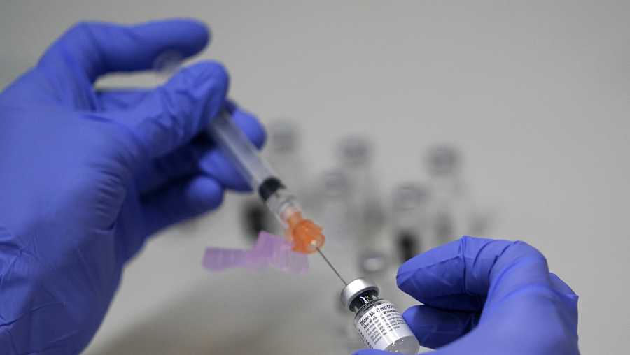 FILE - A pharmacy technician loads a syringe with Pfizer&apos;s COVID-19 vaccine, Tuesday, March 2, 2021, at a mass vaccination site at the Portland Expo in Portland, Maine. U.S. experts are expected to recommend COVID-19 vaccine boosters for all Americans, regardless of age, eight months after they received their second dose of the shot, to ensure lasting protection against the coronavirus as the delta variant spreads across the country. An announcement was expected as soon as this week, with doses beginning to be administered widely once the Food and Drug Administration formally approves the vaccines.  (AP Photo/Robert F. Bukaty)