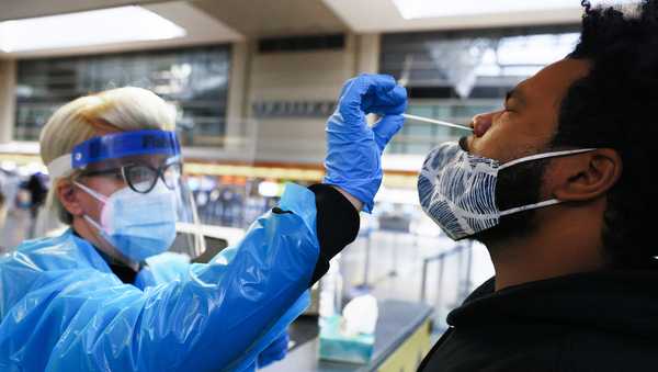 FILE: A man receives a nasal swab COVID-19 test at Tom Bradley International Terminal at Los Angeles International Airport (LAX) amid a coronavirus surge in Southern California on December 22, 2020 in Los Angeles, California.