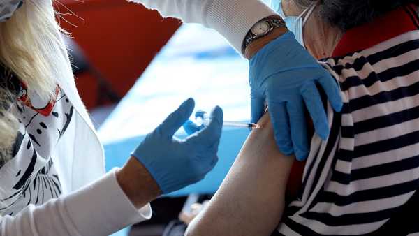 NEW YORK, NEW YORK - JUNE 18: A health care worker administers the vaccine as the Empire State Building offers COVID-19 vaccines at its Observatory on June 18, 2021 in New York City. (Photo by Monica Schipper/Getty Images for Empire State Realty Trust, Inc.)