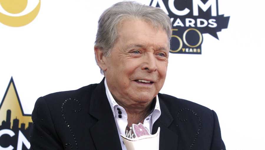 FILE - Mickey Gilley poses with the Triple Crown Award on the red carpet at the 50th annual Academy of Country Music Awards at AT&T Stadium in Arlington, Texas, April 19, 2015. Gilley, whose namesake Texas honky-tonk inspired the 1980 film “Urban Cowboy,” and a nationwide wave of Western-themed nightspots, died Saturday, May 7, 2022, at age 86. (Photo by Jack Plunkett/Invision/AP, File)
