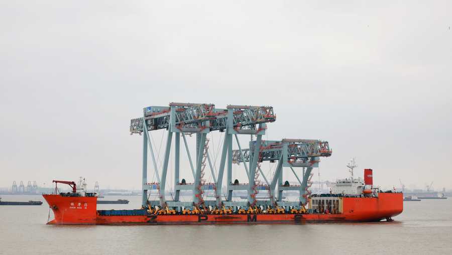 low profile neo-panamax cranes have begun their journey to boston on a ship from shanghai, china