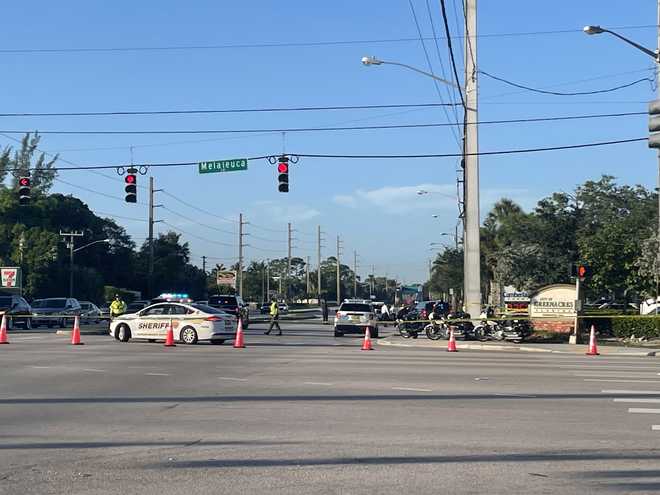 Accident scene under the Melaluca Lane street sign in Greenacres.