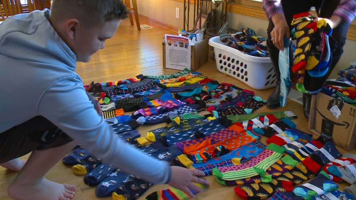 Boy uses passion for crazy socks to bring smiles and warmth to veterans
