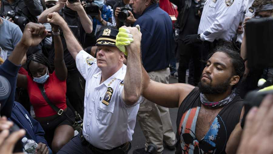 Chief of Department of the New York City Police, Terence Monahan, takes a knee with activists as protesters paused while walking in New York, Monday, June 1, 2020. Demonstrators took to the streets of New York to protest the death of George Floyd, who died May 25 after he was pinned at the neck by a Minneapolis police officer.